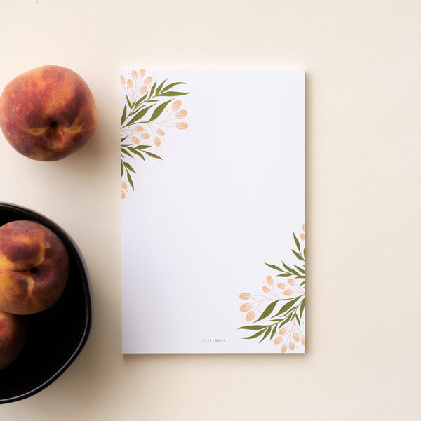 A single 5.5” by 8.5” large notepad with 50 tear-off sheets and an illustration of tuscan florals.