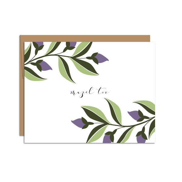 Single folded A2 greeting card with an envelope with an illustration of purple ivy sprigs wrapping the top left corner and bottom right corner of the card. In the center is text that states "Mazel Tov".