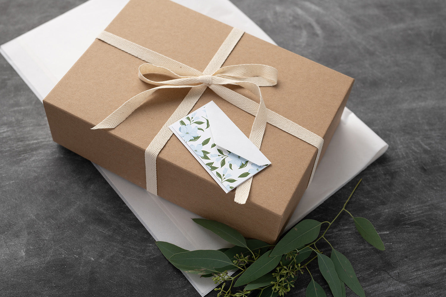Wrapped gift box with hand-illustrated mini note card and blue floral envelope