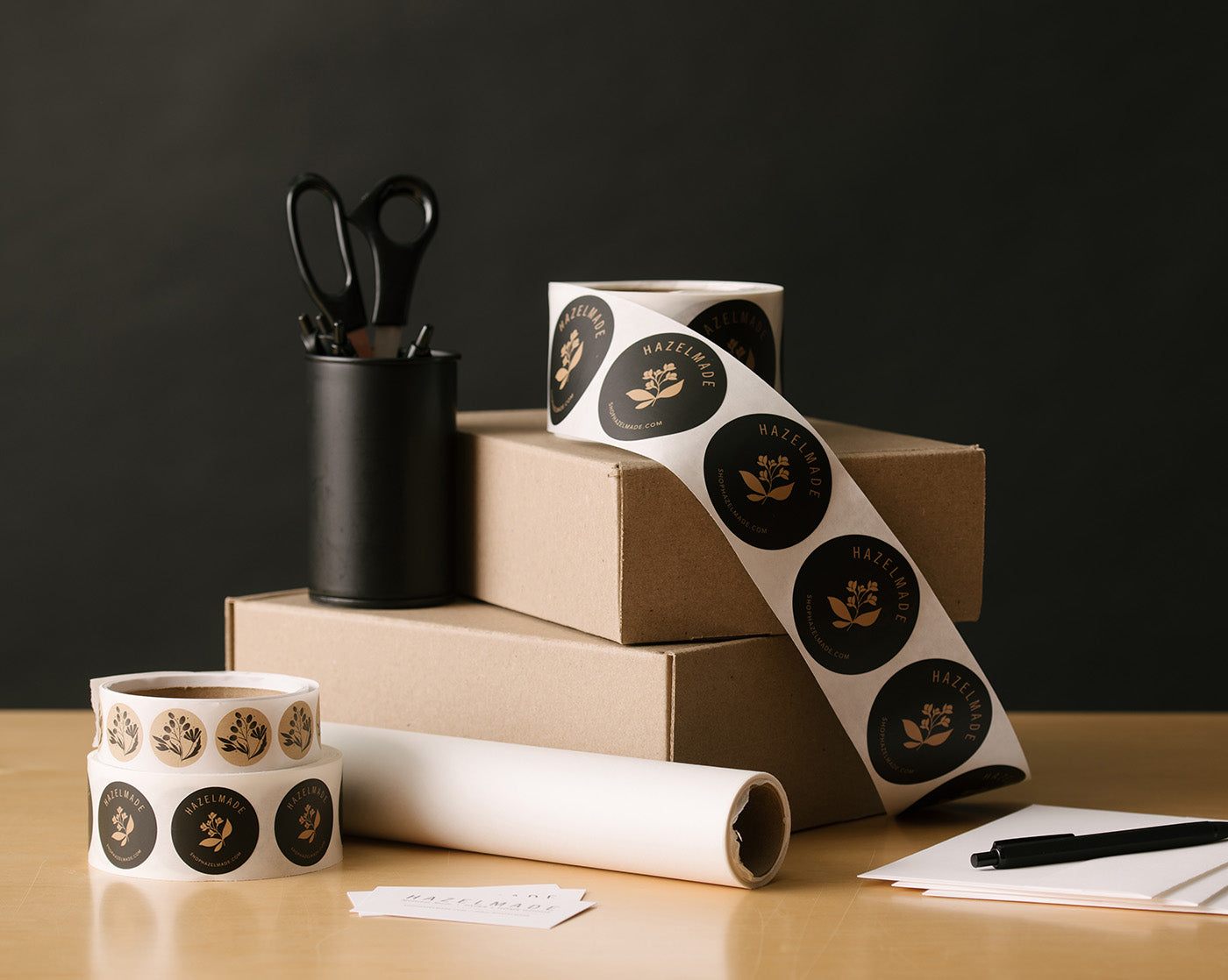 Hazelmade packaging materials and branded labels arranged on a desk