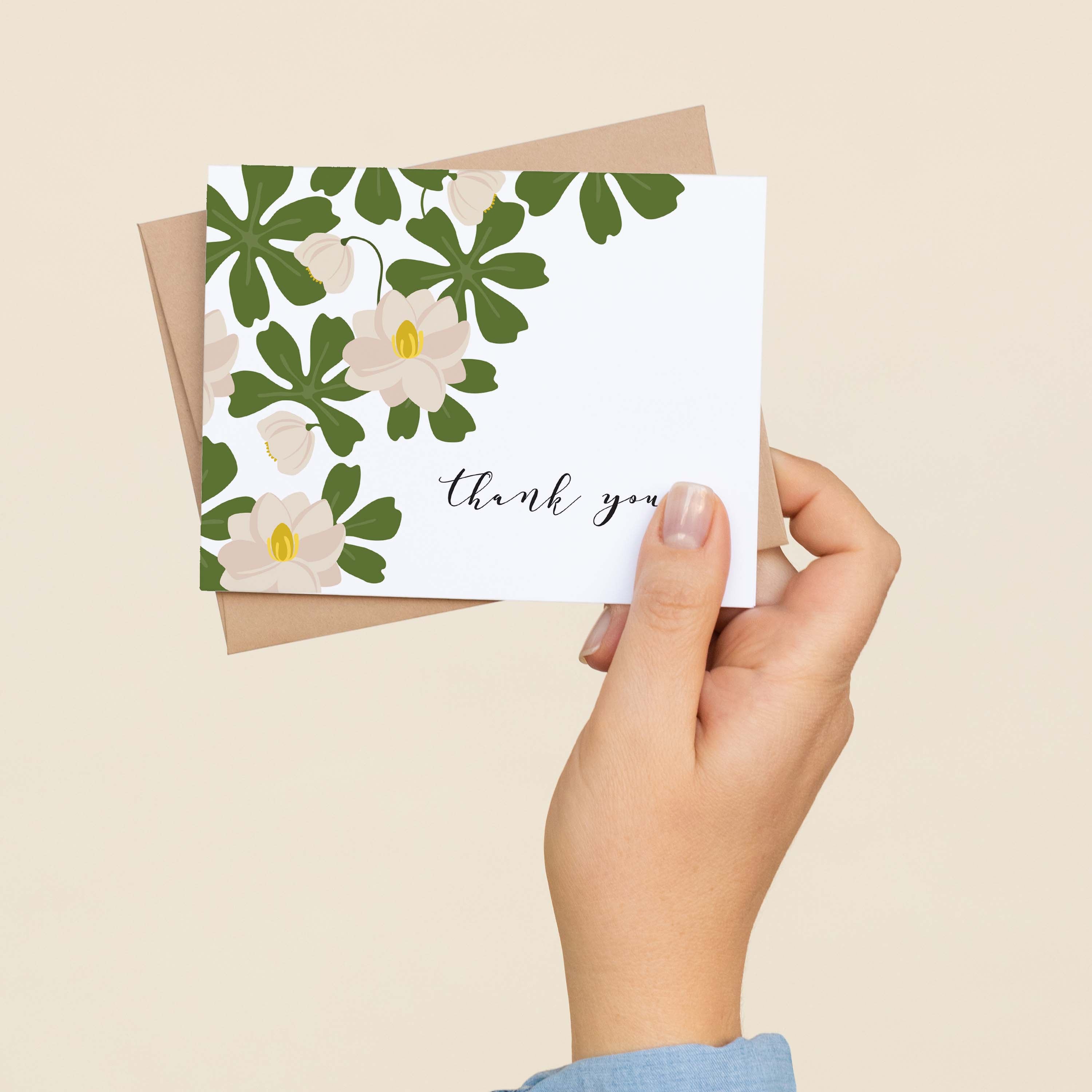 A hand holding a Mayapple Thank You greeting card showing the hand-illustrated mayapple flower design