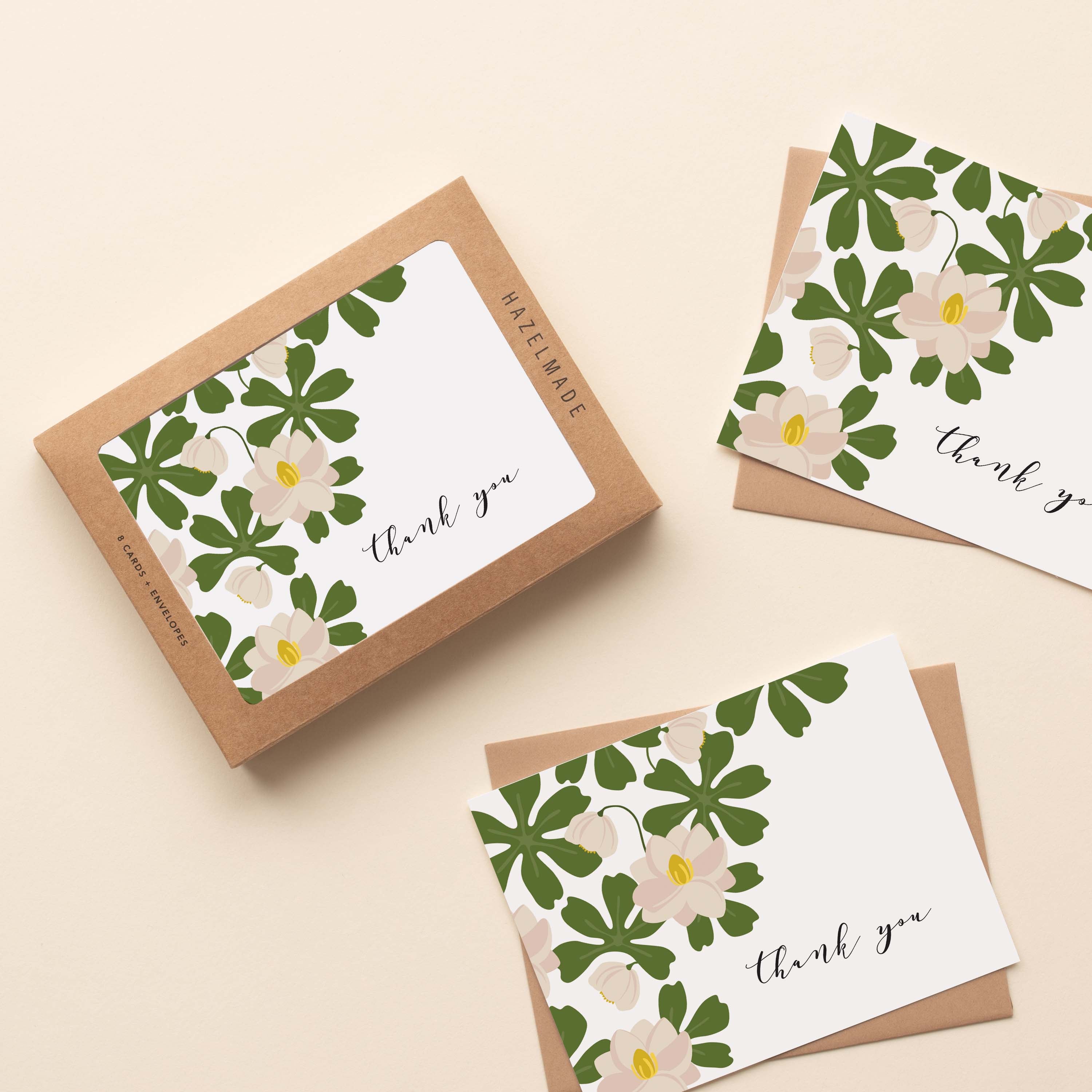 A boxed set of Mayapple Thank You Greeting Cards sitting with two cards and their envelopes featuring a hand-illustrated mayapple flower design