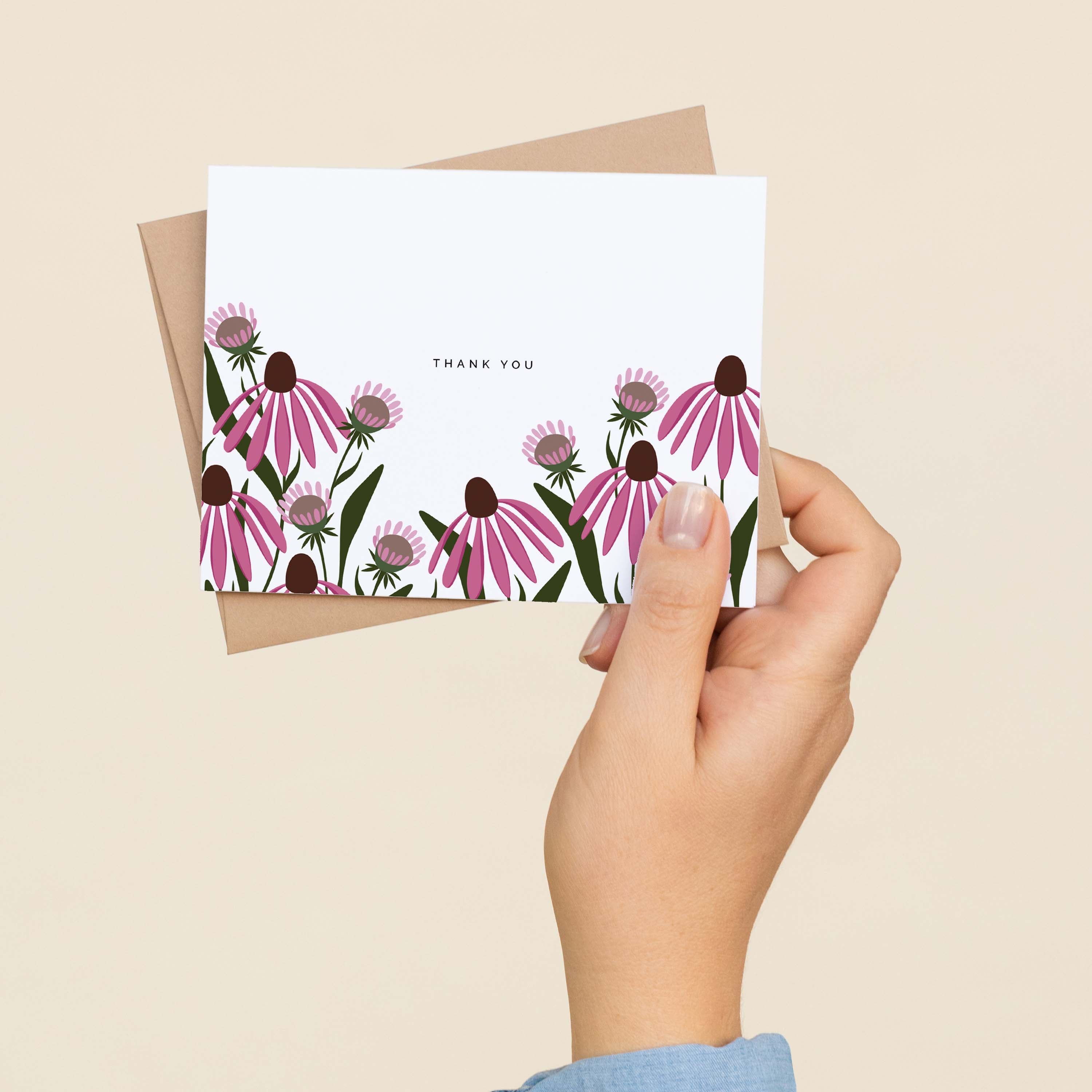 A hand holding an Echinacea Thank You greeting card showing the hand-illustrated echinacea flower design
