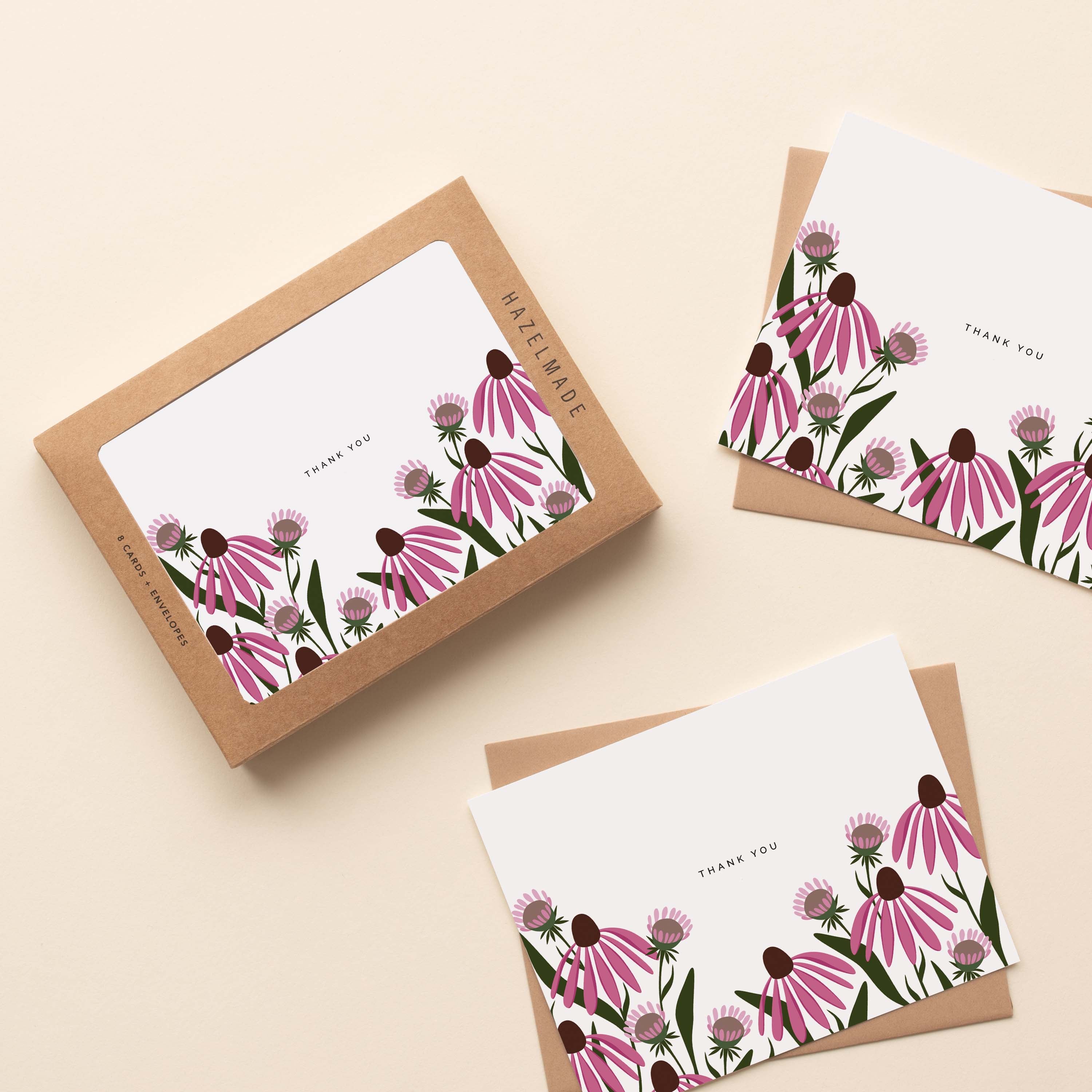 A boxed set of Echinacea Thank You Greeting Cards sitting with two cards and their envelopes featuring a hand-illustrated echinacea flower design