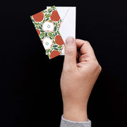 Hand holding a Harvest Apples Mini Note Card with a white envelope against a dark background