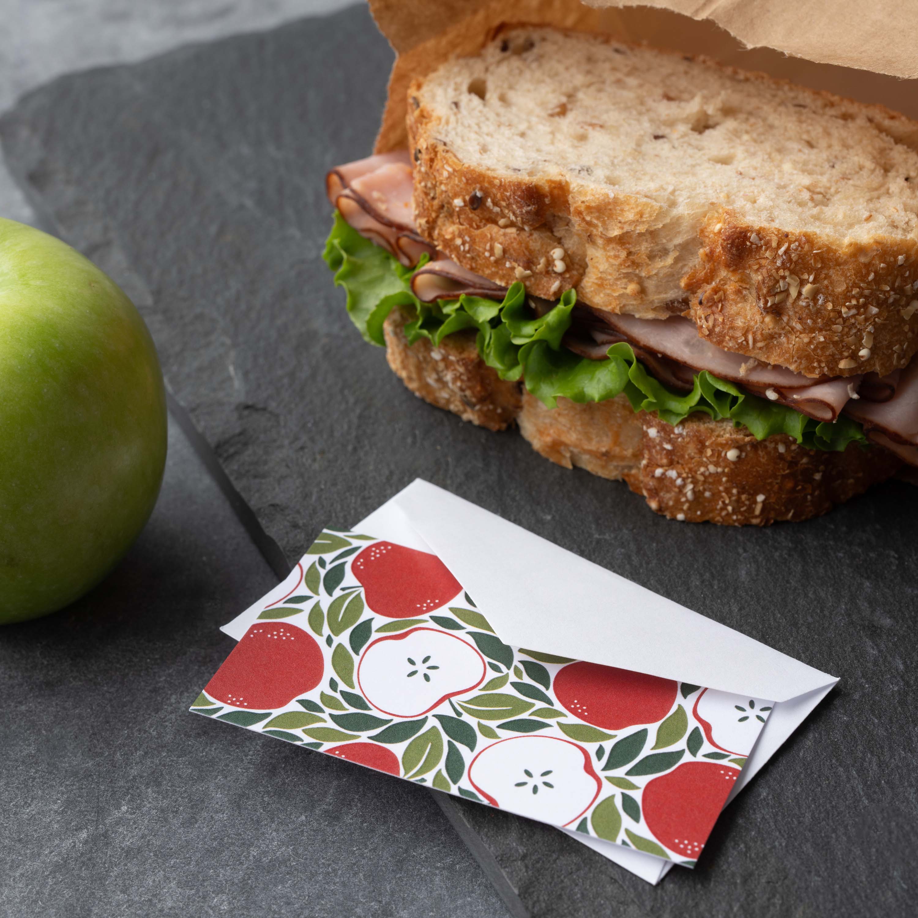 Harvest Apples Mini Note Card styled beside a sandwich and green apple on a dark surface