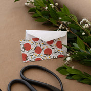 Tomatoes Mini Note Card styled with a white envelope, greenery, and scissors on kraft paper