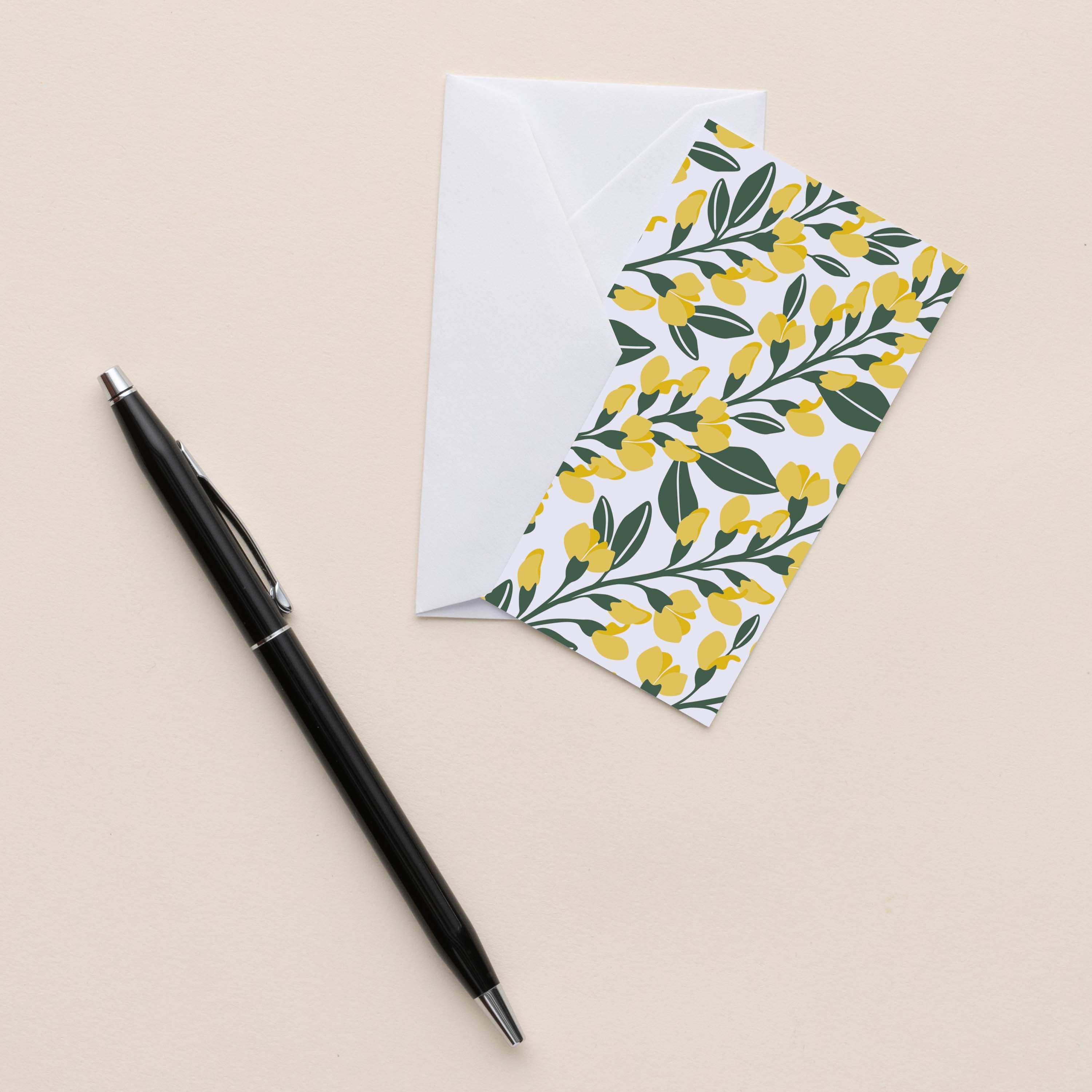 Sundrops Mini Note Card with white envelope beside a black pen on a neutral background