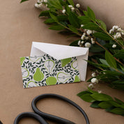 Pears Mini Note Card styled with a white envelope, greenery, and scissors on kraft paper
