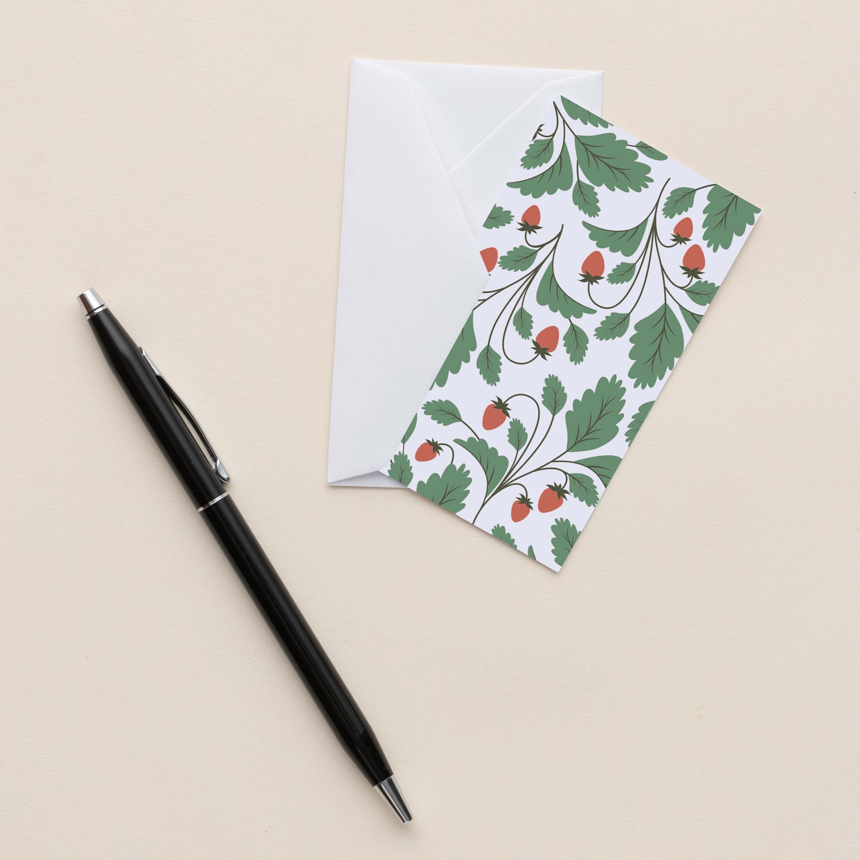 Wild Strawberries Mini Note Card with white envelope beside a black pen on a neutral background