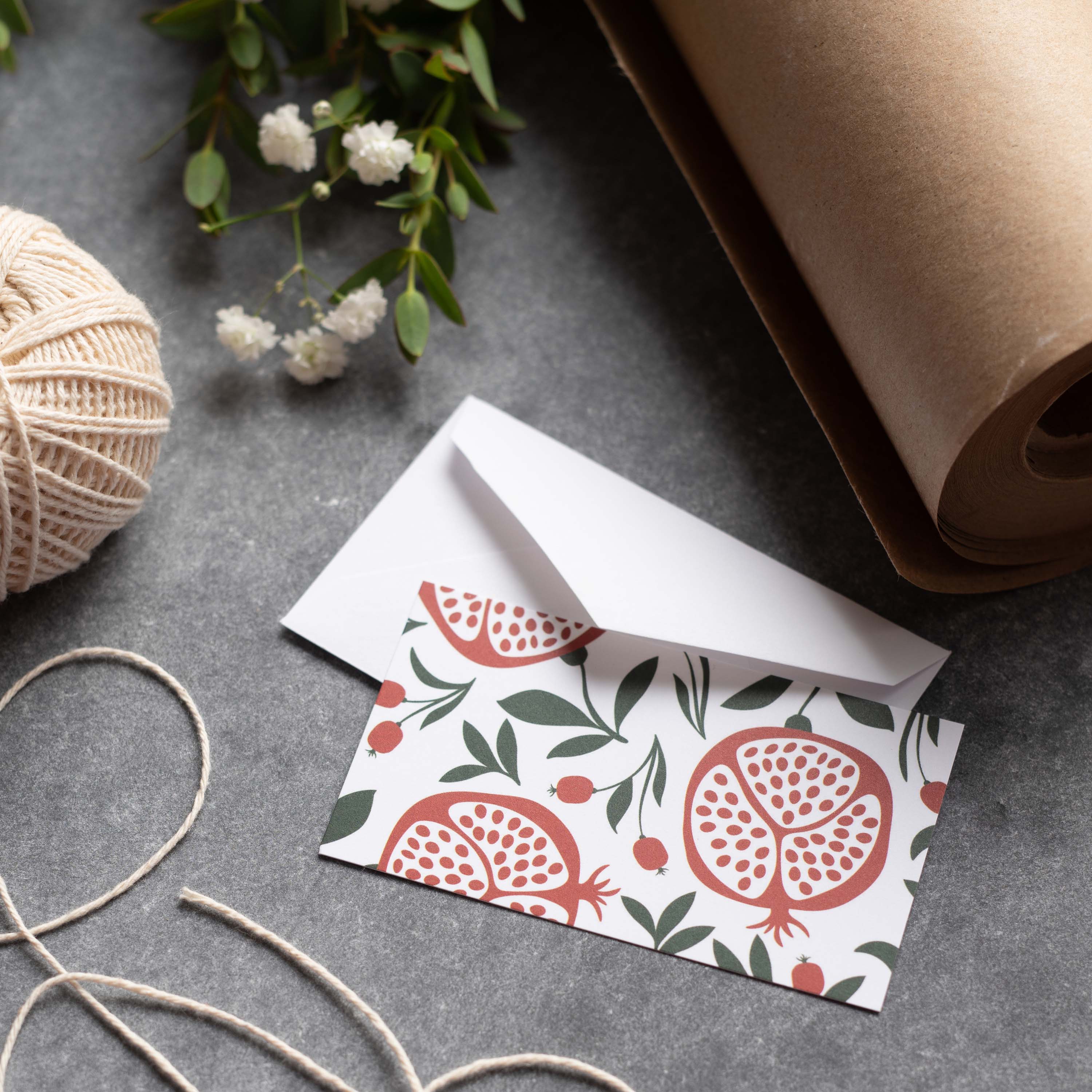 Pomegranates Mini Note Card styled with twine and wrapping paper on a gray surface