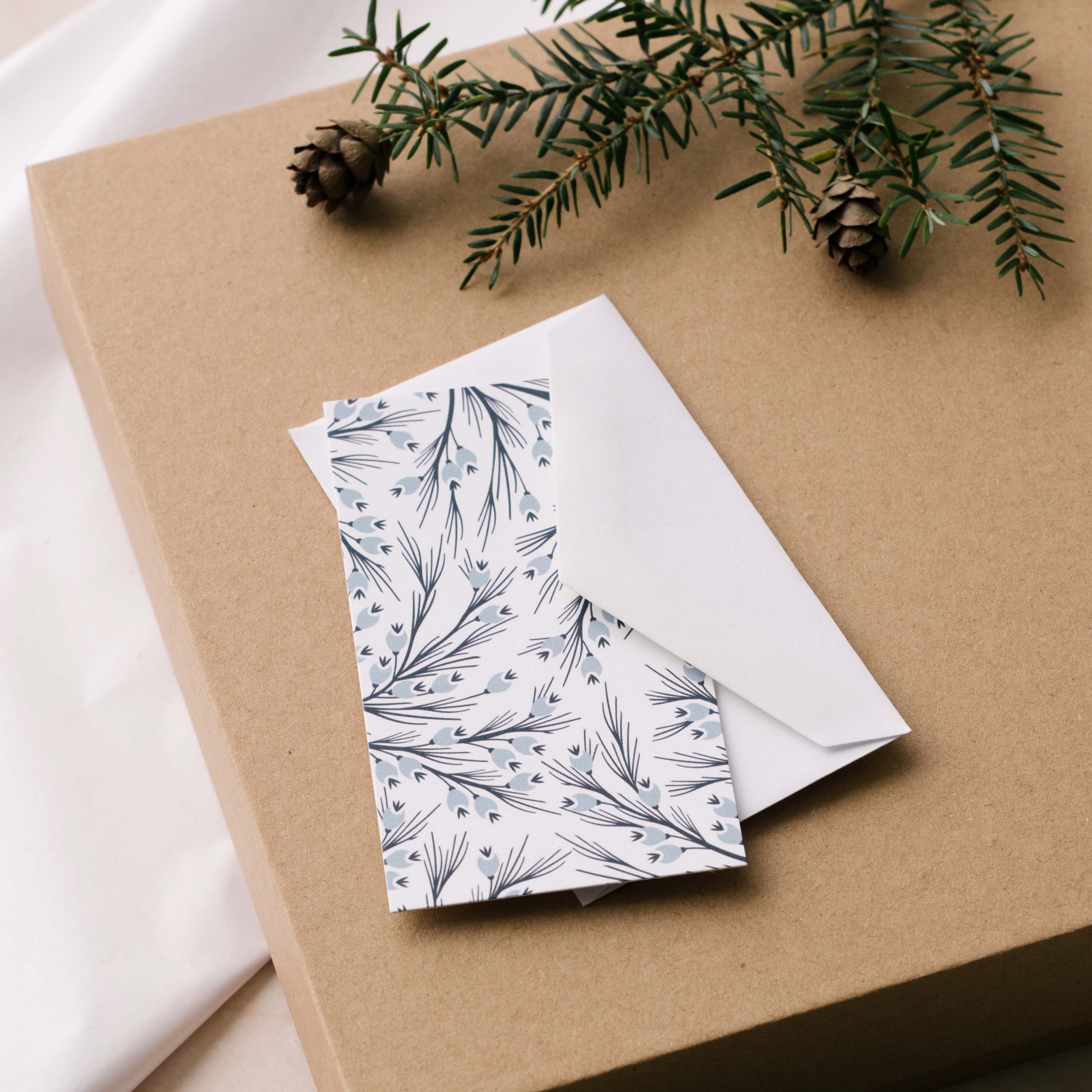 Winter Branch Mini Note Card and white envelope styled on a gift box with greenery