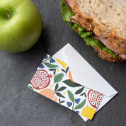 Fruit Basket Mini Note Card styled beside a sandwich and green apple on a gray surface
