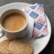 Sardines Mini Note Card styled beside a cup of coffee and cookie on a plate