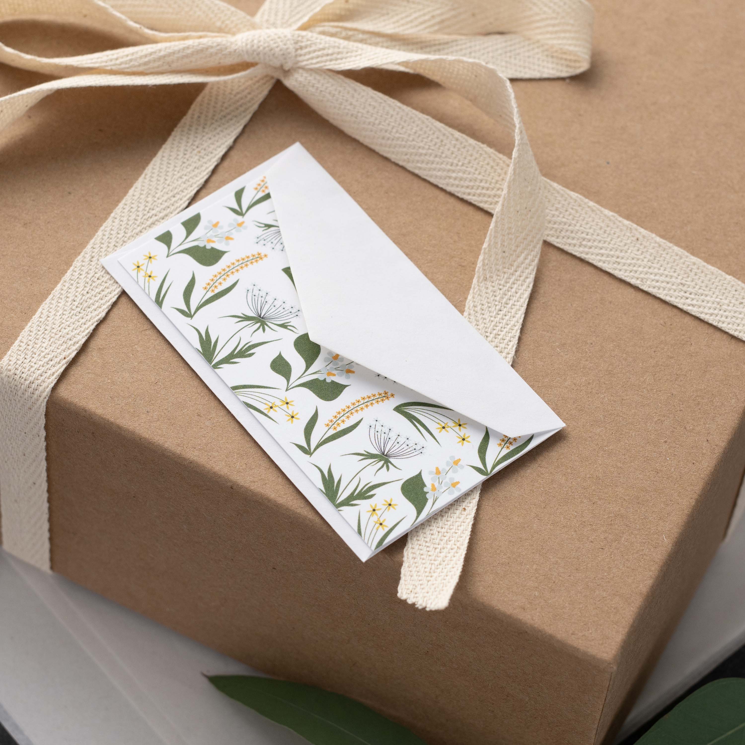 Wildflowers Mini Note Card styled on a wrapped gift box with ribbon