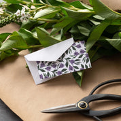 Tulips Mini Note Card styled with a white envelope, greenery, and scissors on kraft paper