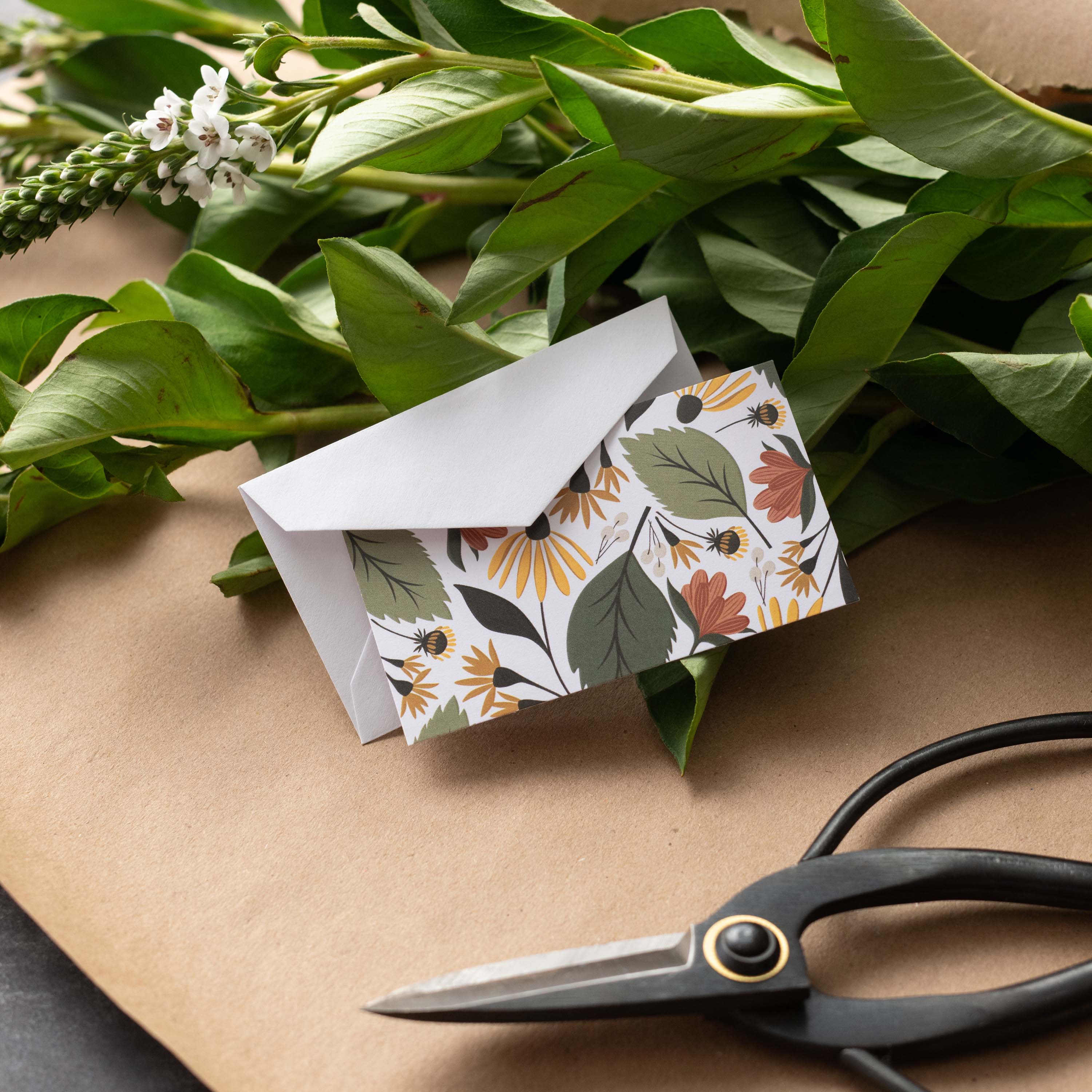Fall Florals Mini Note Card styled with a white envelope, greenery, and scissors on kraft paper