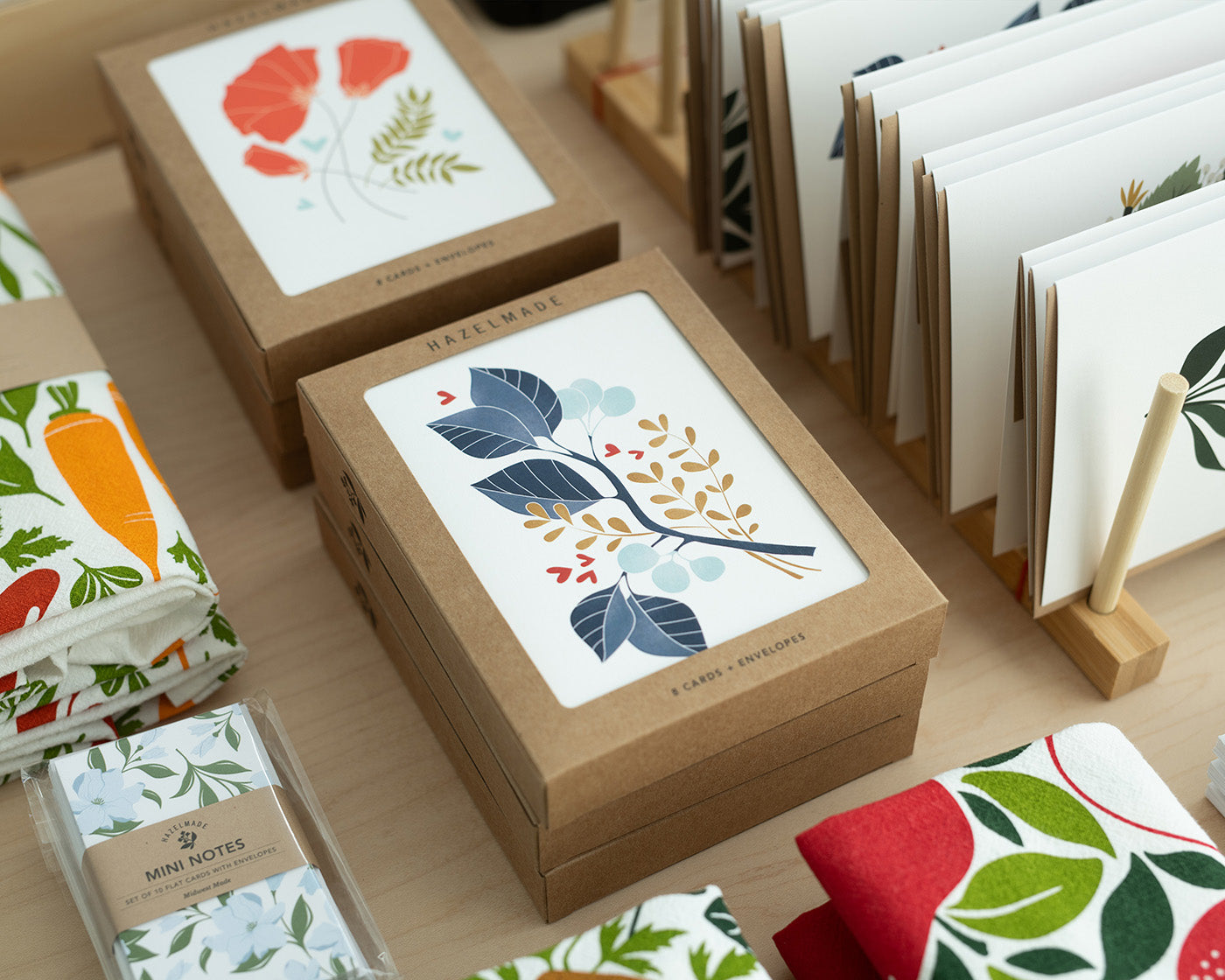 Hazelmade boxed cards, stationery, and product display materials arranged on a tabletop