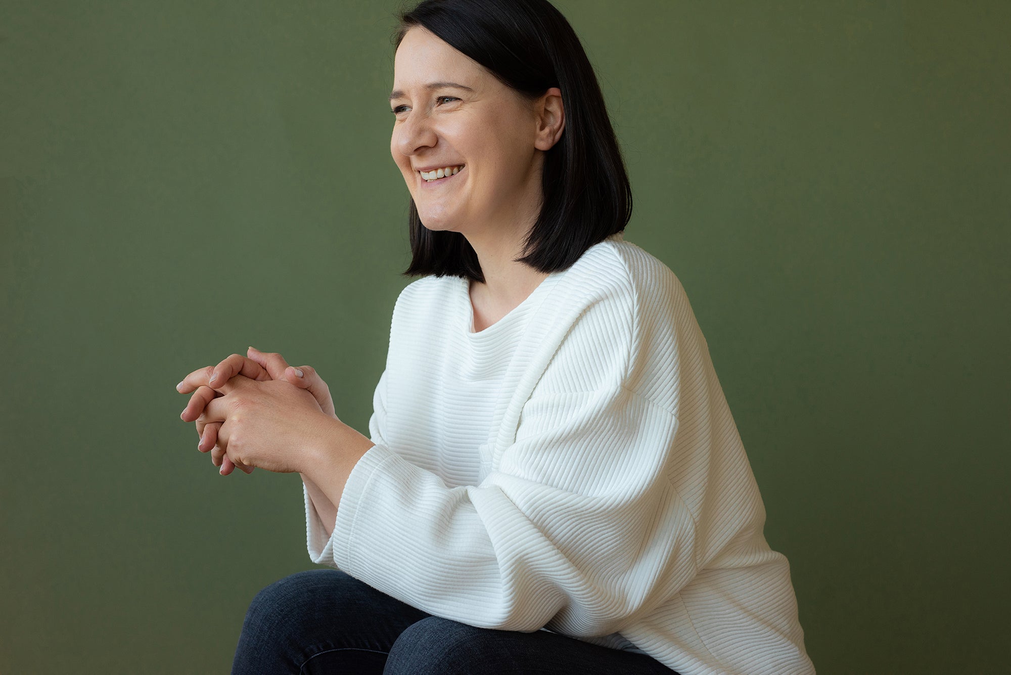 Portrait of Susan Hazel Rich seated against a green background