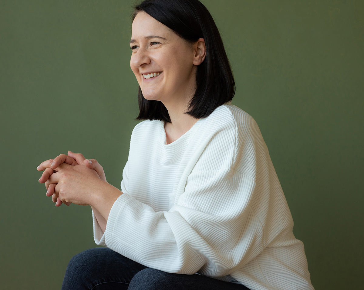 Portrait of Susan Hazel Rich seated against a green background