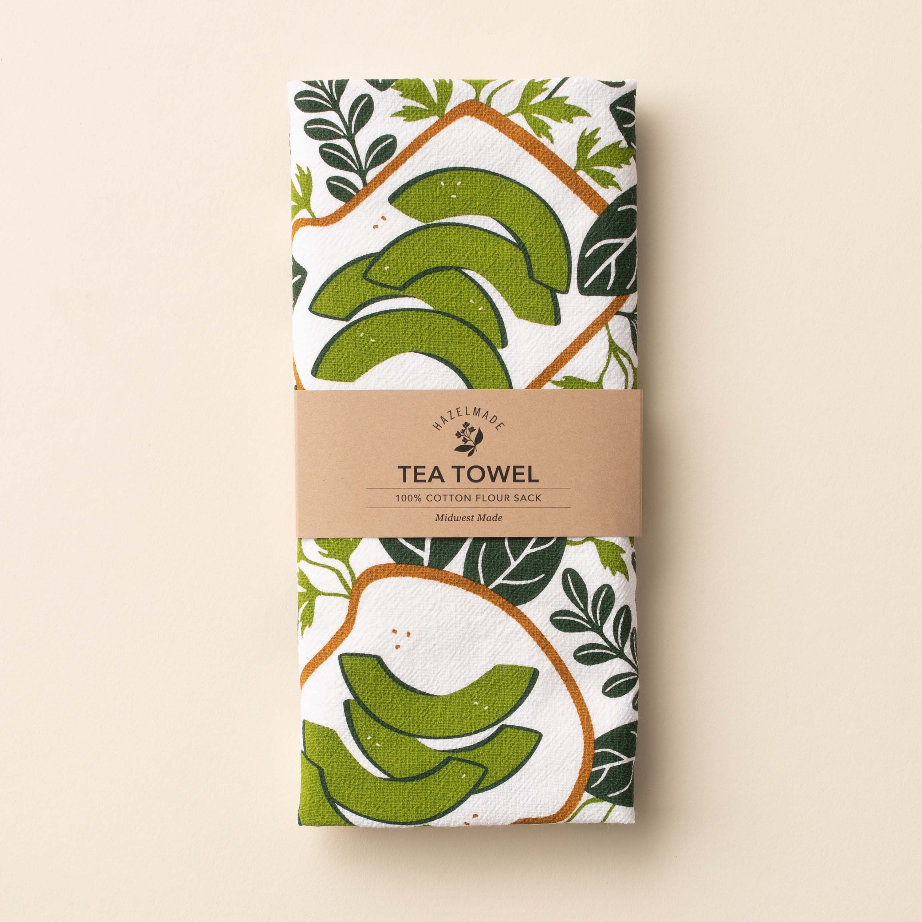 Folded Avocado Toast Tea Towel with wrap band and hand-illustrated avocado toast design