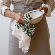 Blackberry Vines Tea Towel held by a person drying a bowl.