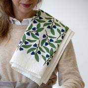 Blueberry Bushel Tea Towel draped over a person’s shoulder
