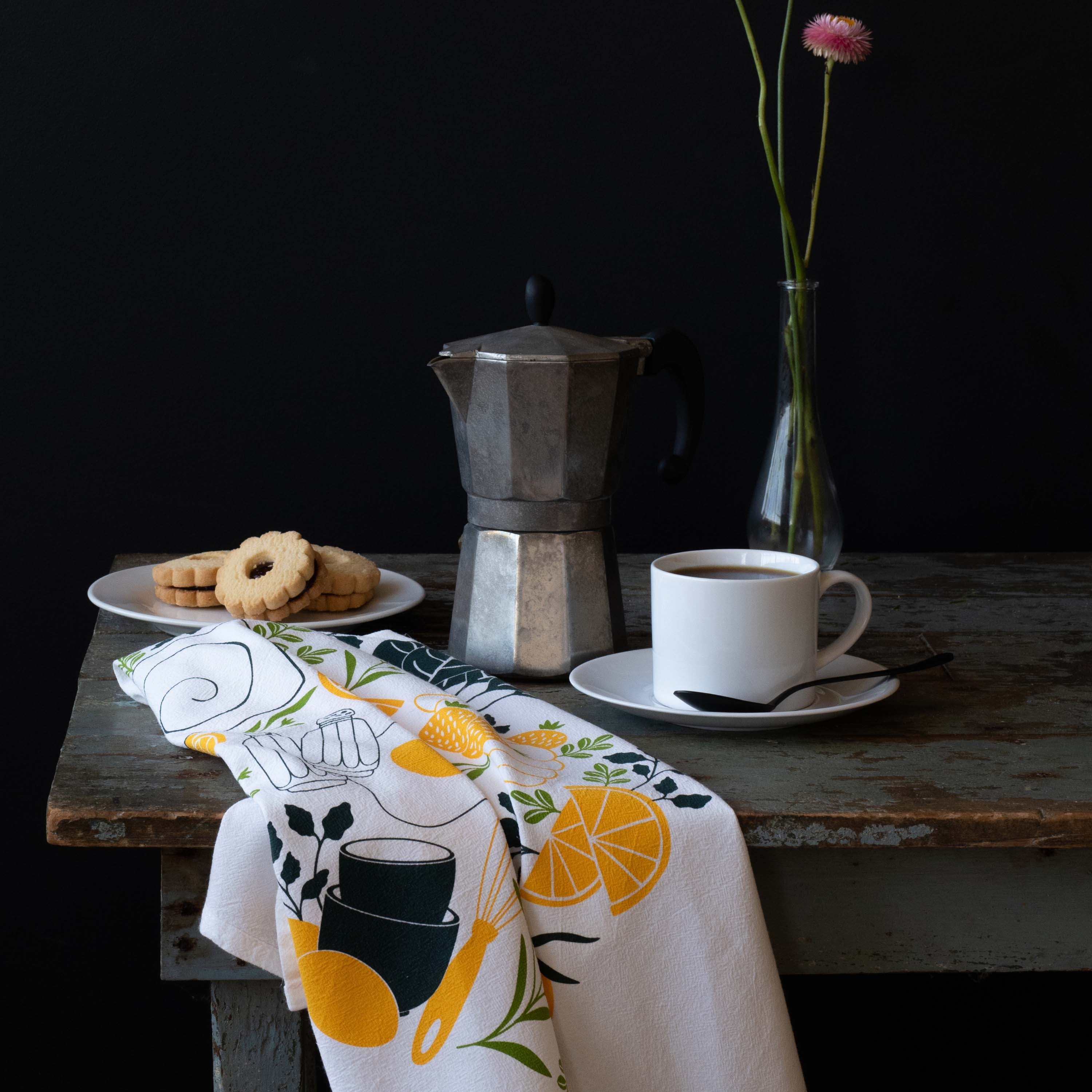 Breakfast Diner Tea Towel draped over a table beside a moka pot, coffee cup, and pastries