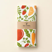 Folded Orange Farmers Market Tea Towel with wrap band and hand-illustrated vegetable and citrus design