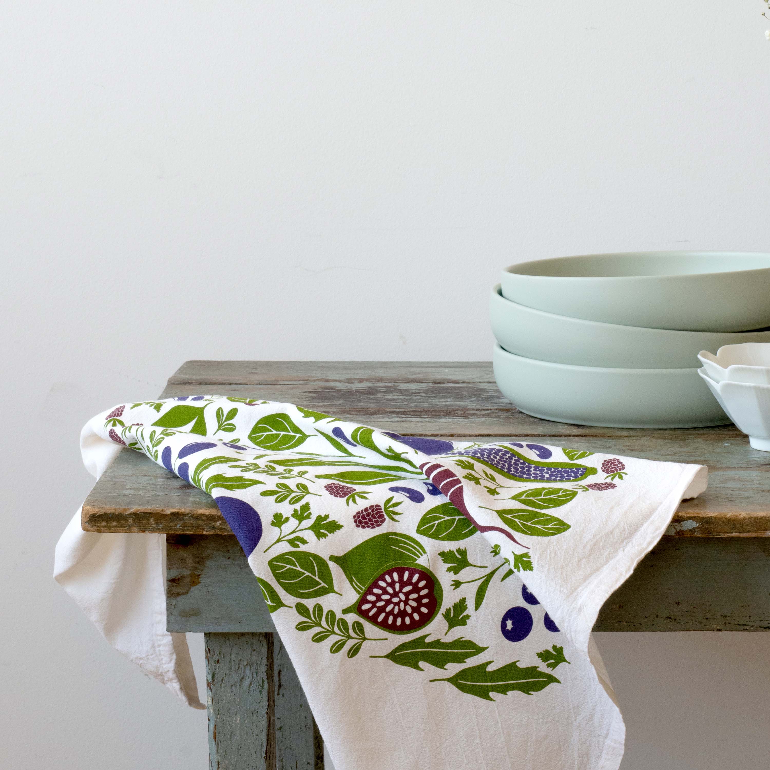 Purple Farmers Market Tea Towel draped over a rustic table beside bowls