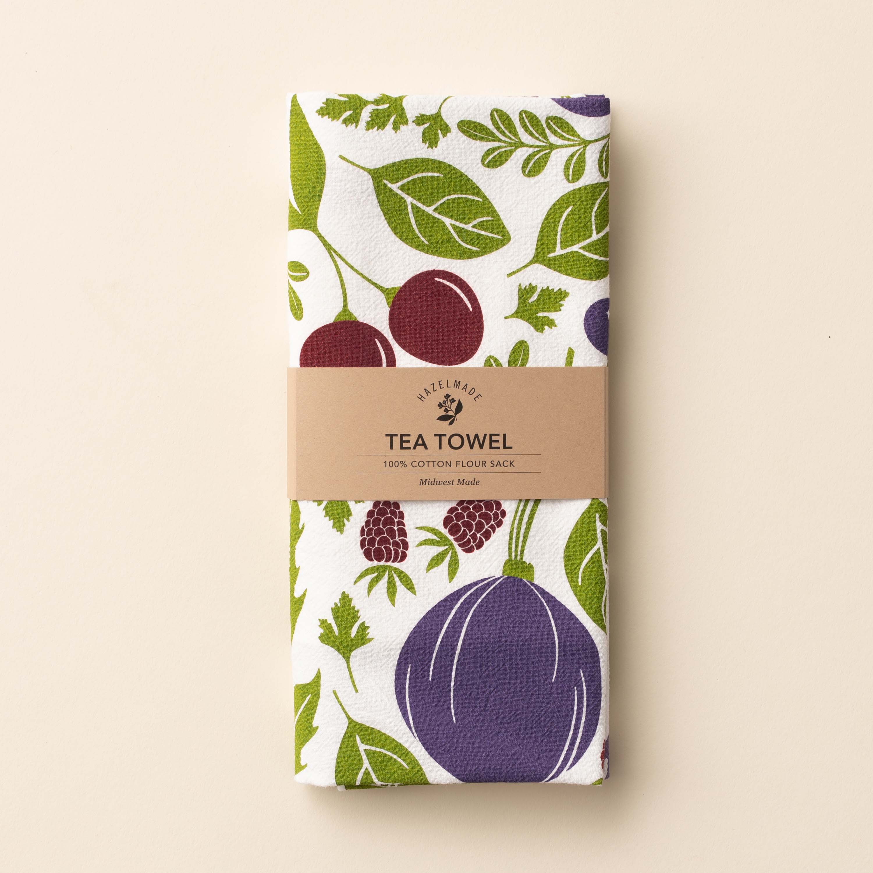 Folded Purple Farmers Market Tea Towel with wrap band and hand-illustrated vegetable and berries design
