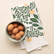 House Plants Tea Towel with hand-illustrated house plant design beside a bowl of brown eggs