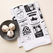 Italian Market Tea Towel with hand-illustrated Italian pantry design beside garlic bulbs