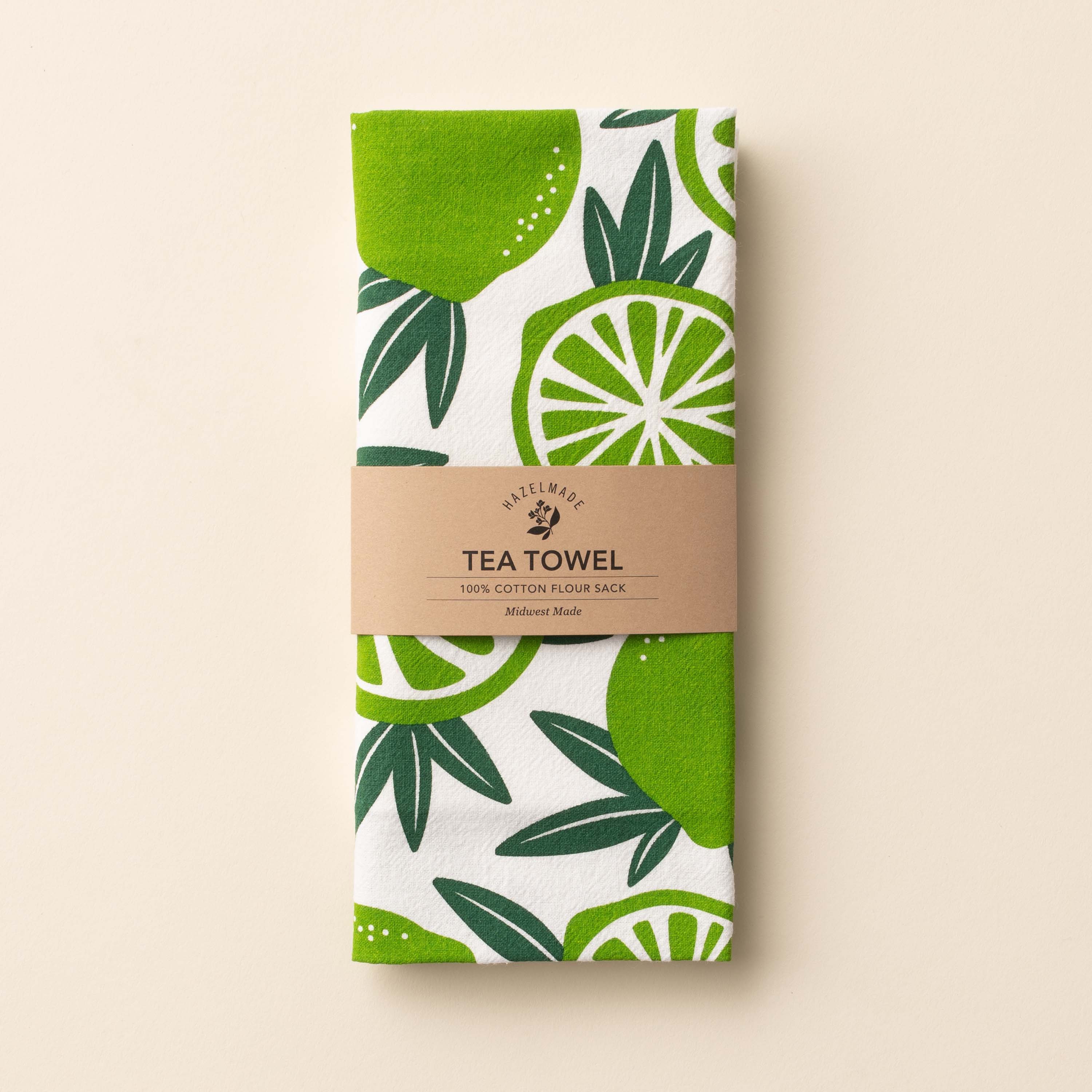 Folded Limes Tea Towel with wrap band and hand-illustrated lime design