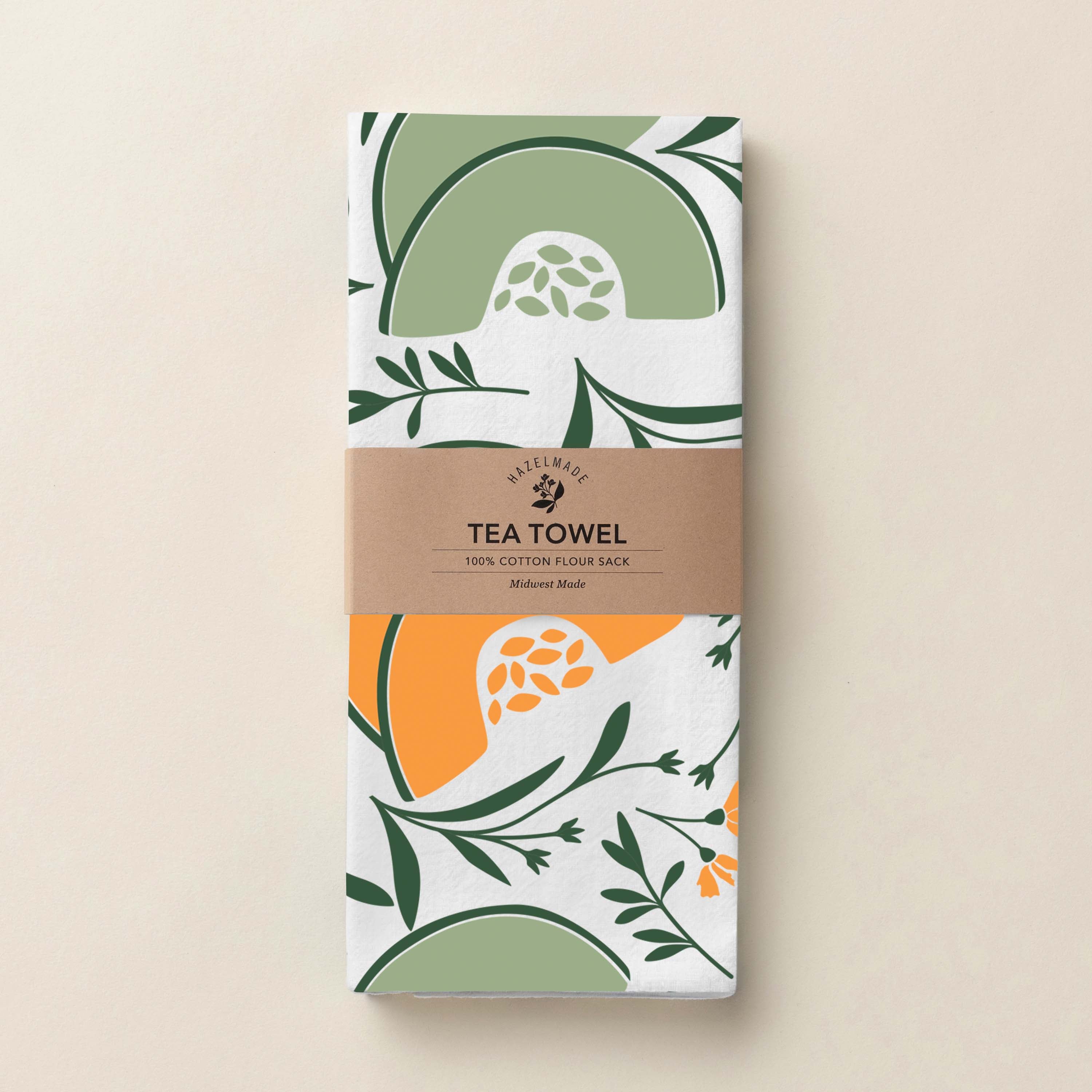Folded Cantaloupe + Honeydew Tea Towel with wrap band and hand-illustrated cantaloupe and honeydew pattern