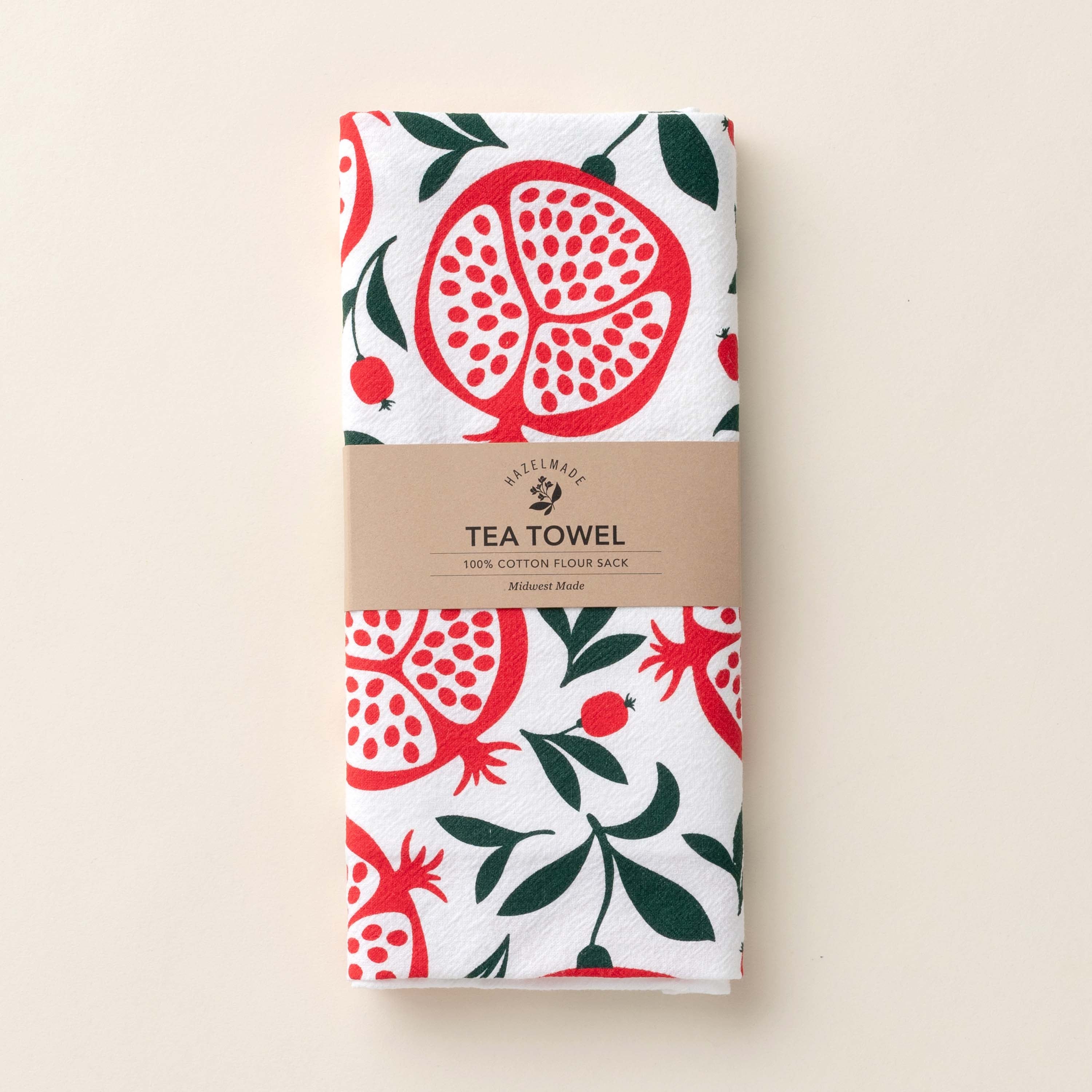 Folded Pomegranates Tea Towel with wrap band and hand-illustrated pomegranate design