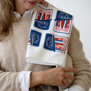 Person holding the Sardines Tea Towel over their shoulder