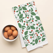 Wild Strawberries Tea Towel with hand-illustrated wild strawberry design beside a bowl of brown eggs