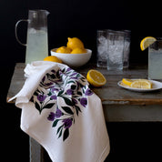Tulips Tea Towel draped over a table beside lemons, glasses, and a pitcher