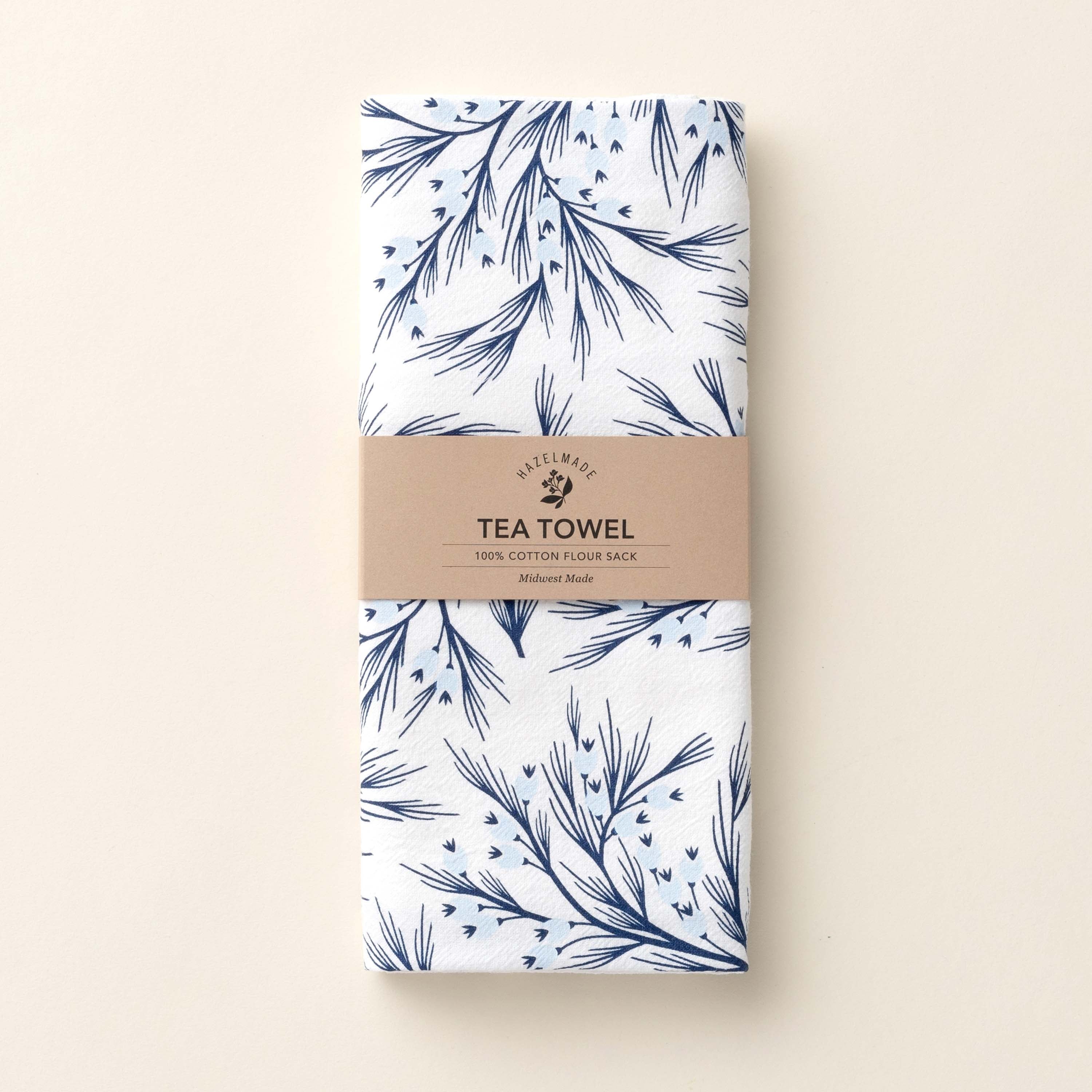 Folded Winter Branch Tea Towel with wrap band and hand-illustrated winter branch design