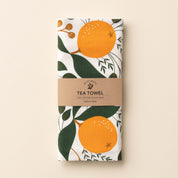 Folded Winter Citrus Tea Towel with wrap band and hand-illustrated citrus design
