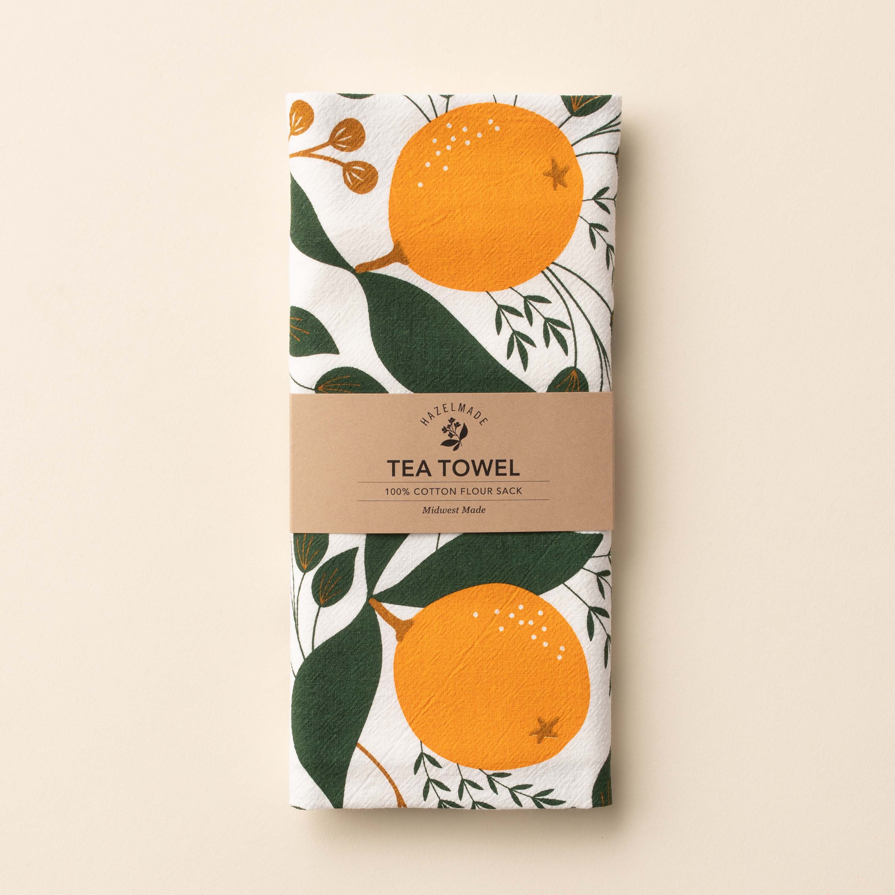Folded Winter Citrus Tea Towel with wrap band and hand-illustrated citrus design
