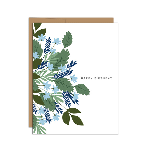 Single folded A2 greeting card with an envelope with an illustration of blue flowers and green leaves wrapping the left side of the card. The right side of the card states "Happy Birthday".