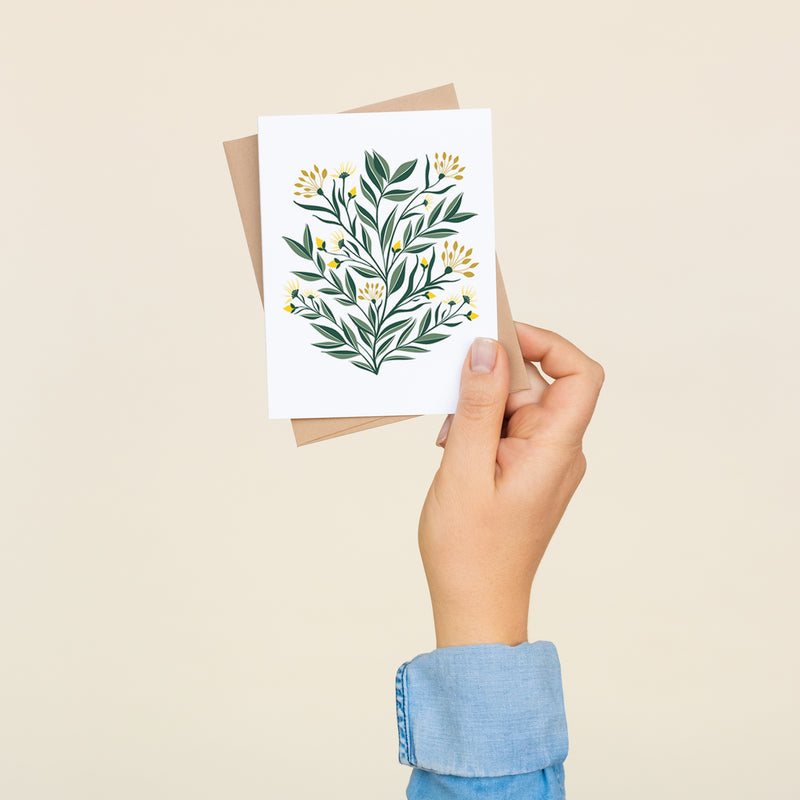 Box set of 8 folded A2 greeting cards with envelopes with an illustration yellow aster flowers and green leaves.