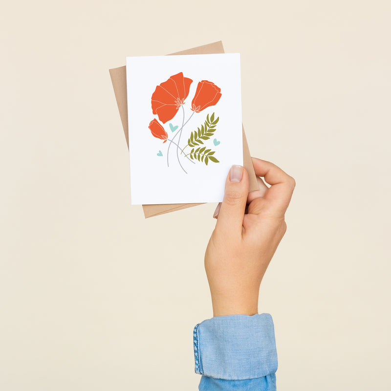 Box set of 8 folded A2 greeting cards with envelopes with an illustration of red poppies and green/brown wheat.