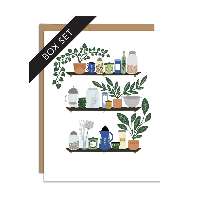 Box set of 8 folded A2 greeting cards with envelopes with an illustration of three shelves displaying various kitchen items such as a french press, mugs, and plants.