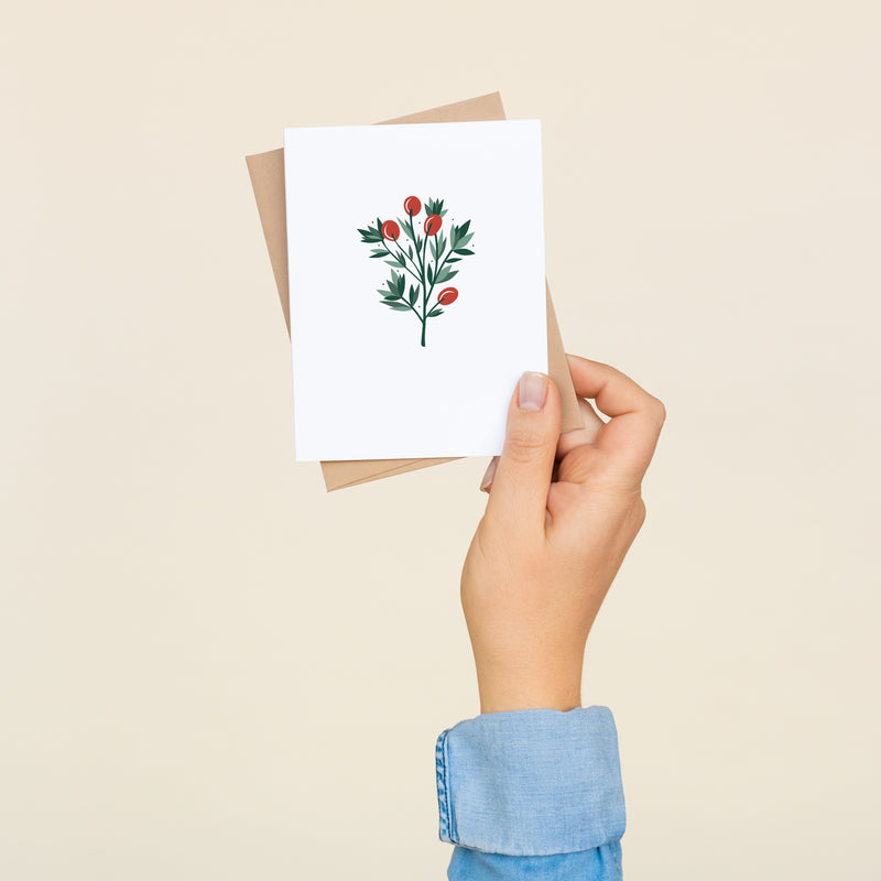 Single folded A2 greeting card with an envelope with an illustration of a sprig of red holly berries and green leaves.