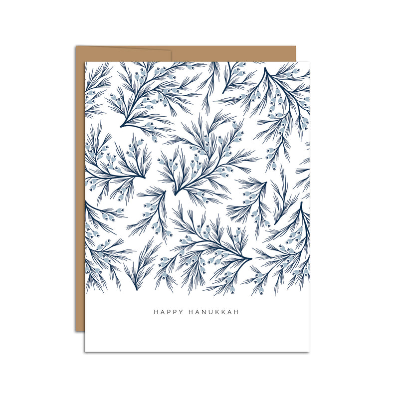 Single folded A2 greeting card with an envelope with an illustration of dark blue branches and light blue detail. Below this pattern of branches is text that states "Happy Hanukkah".