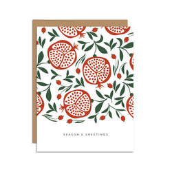 Single folded A2 greeting card with an envelope with an illustration of a pattern of pomegranates open with seeds and below the pattern is text that states "Season's Greetings".