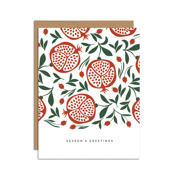 Single folded A2 greeting card with an envelope with an illustration of a pattern of pomegranates open with seeds and below the pattern is text that states "Season's Greetings".
